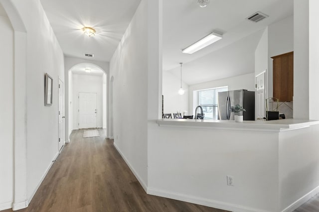 107 Chandler View Trl, Round Rock, TX 78665 - kitchen with freestanding refrigerator, arched walkways, dark wood-type flooring, and lofted ceiling