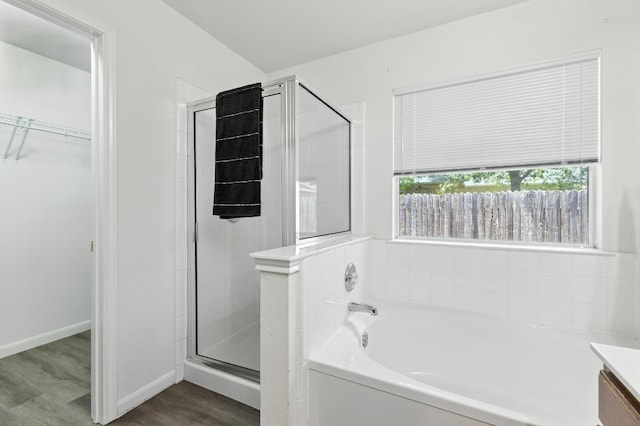 107 Chandler View Trl, Round Rock, TX 78665 - full bathroom featuring a garden tub, a spacious closet, a stall shower, wood finished floors, and vanity