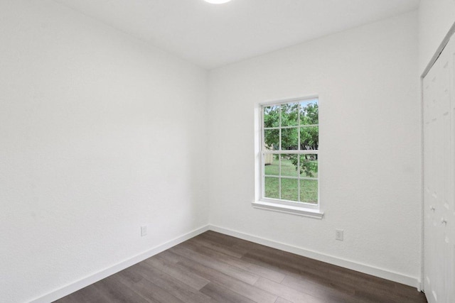 707 Mason St, Leander, TX 78641 - unfurnished bedroom featuring dark wood-style floors, multiple windows, and a closet