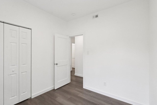 707 Mason St, Leander, TX 78641 - unfurnished bedroom with dark wood-style floors and a closet