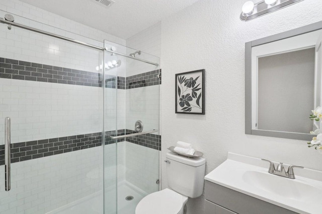 707 Mason St, Leander, TX 78641 - full bath featuring vanity, a shower stall, a textured wall, and a textured ceiling