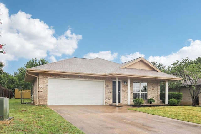 707 Mason St, Leander, TX 78641 - ranch-style home with concrete driveway, a garage, and brick siding