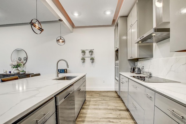 11300 Lake Dr, Austin, TX 78748 - kitchen featuring wall chimney range hood, appliances with stainless steel finishes, gray cabinetry, light wood-type flooring, and decorative backsplash