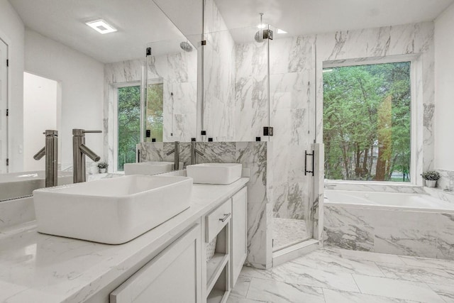 11300 Lake Dr, Austin, TX 78748 - full bathroom with marble tiled floors, vanity, a garden tub, and a marble finish shower