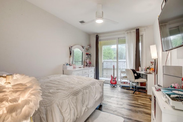 11300 Lake Dr, Austin, TX 78748 - bedroom with access to outside, wood finished floors, ceiling fan, and freestanding refrigerator