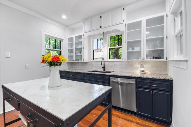 603 E Liberty Ave, Round Rock, TX 78664 - kitchen with stainless steel dishwasher, white cabinetry, tasteful backsplash, dark wood finished floors, and recessed lighting