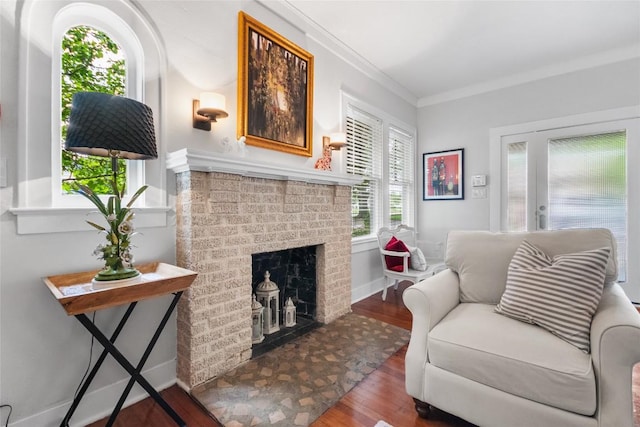 603 E Liberty Ave, Round Rock, TX 78664 - living area featuring wood finished floors, a fireplace, and ornamental molding