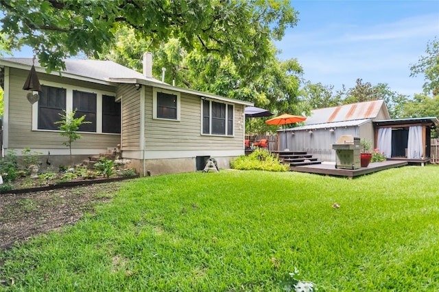 603 E Liberty Ave, Round Rock, TX 78664 - rear view of property with a deck, a lawn, and a chimney