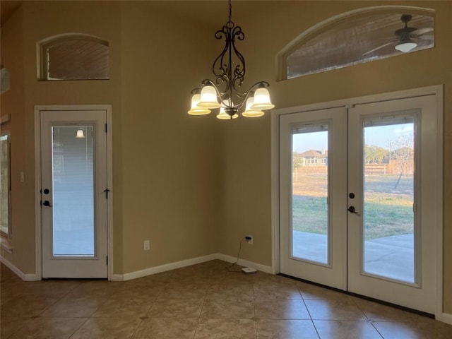 129 S Abrego Xing S, Floresville, TX 78114 - doorway to outside with french doors, a chandelier, light tile patterned floors, and a high ceiling