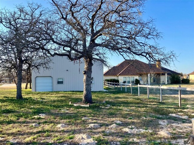 129 S Abrego Xing S, Floresville, TX 78114 - view of yard with a garage
