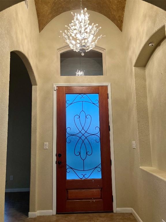 129 S Abrego Xing S, Floresville, TX 78114 - entrance foyer featuring a chandelier and arched walkways