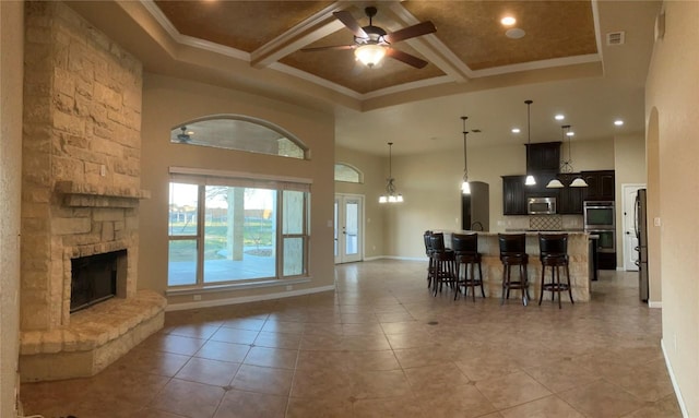129 S Abrego Xing S, Floresville, TX 78114 - kitchen with appliances with stainless steel finishes, open floor plan, ornamental molding, a ceiling fan, and coffered ceiling