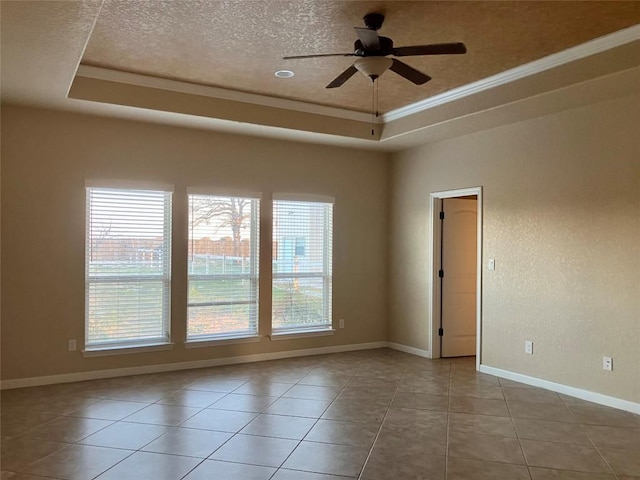 129 S Abrego Xing S, Floresville, TX 78114 - unfurnished room with healthy amount of natural light, a tray ceiling, a ceiling fan, a textured ceiling, and ornamental molding