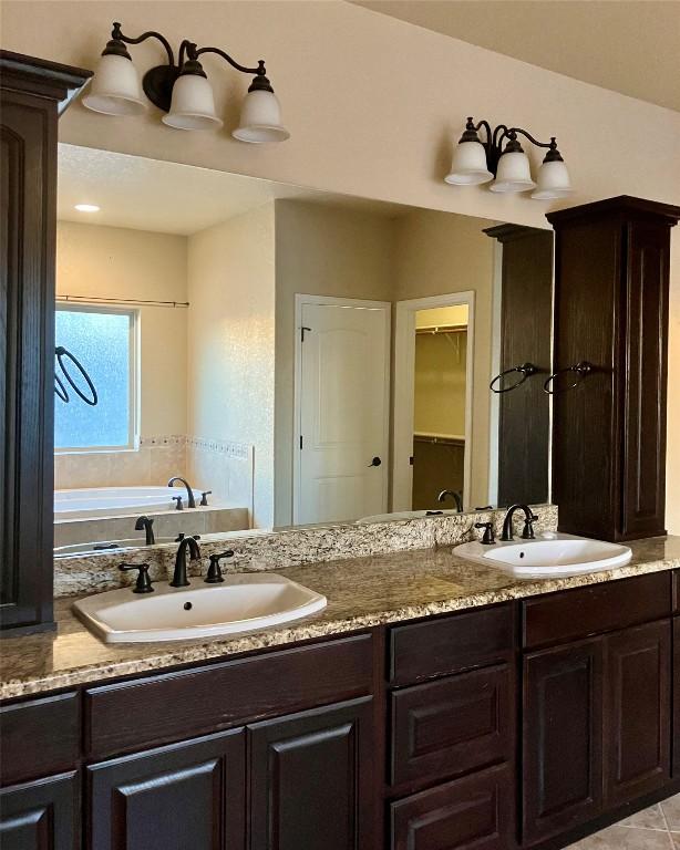 129 S Abrego Xing S, Floresville, TX 78114 - full bath featuring double vanity and a bath