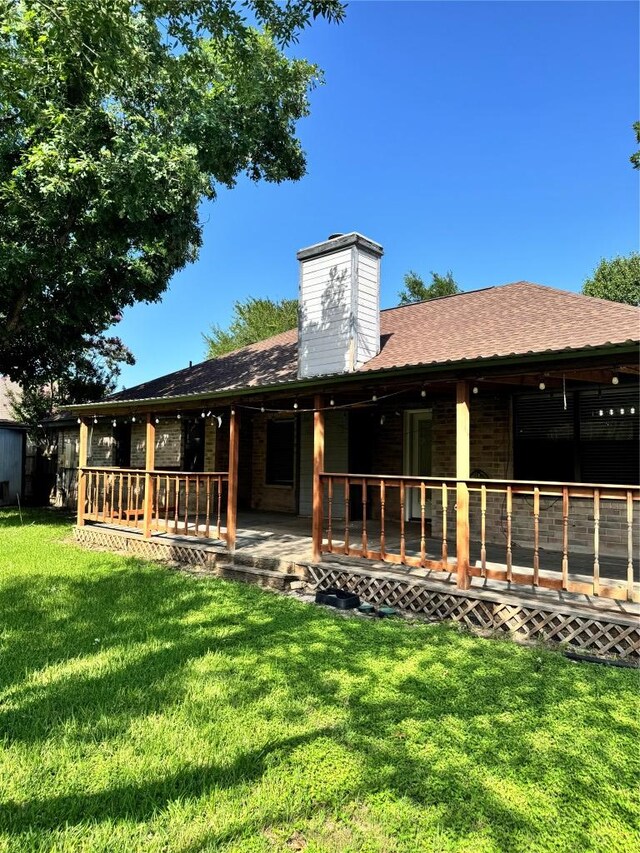 1000 Twin Creek Dr, Pflugerville, TX 78660 - rear view of property with a lawn, a shingled roof, and a chimney