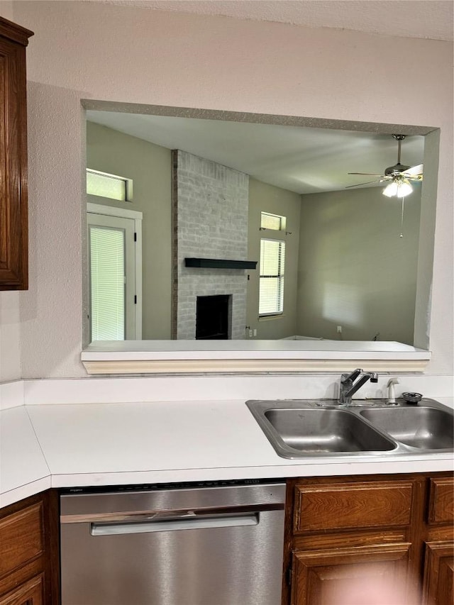 1000 Twin Creek Dr, Pflugerville, TX 78660 - kitchen with dishwasher, light countertops, a brick fireplace, and a ceiling fan