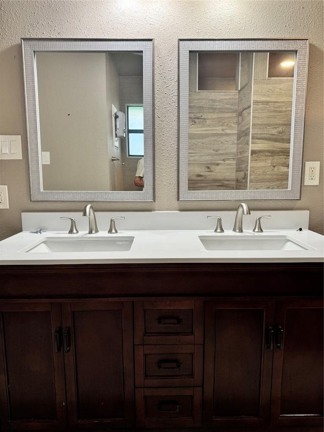 1000 Twin Creek Dr, Pflugerville, TX 78660 - bathroom featuring double vanity and a textured wall