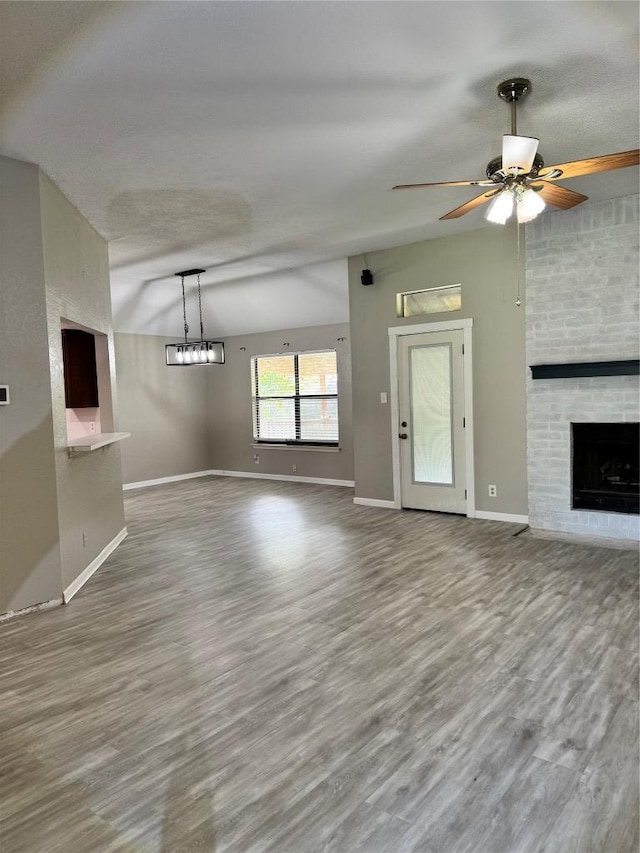 1000 Twin Creek Dr, Pflugerville, TX 78660 - unfurnished living room featuring wood finished floors, a brick fireplace, and ceiling fan