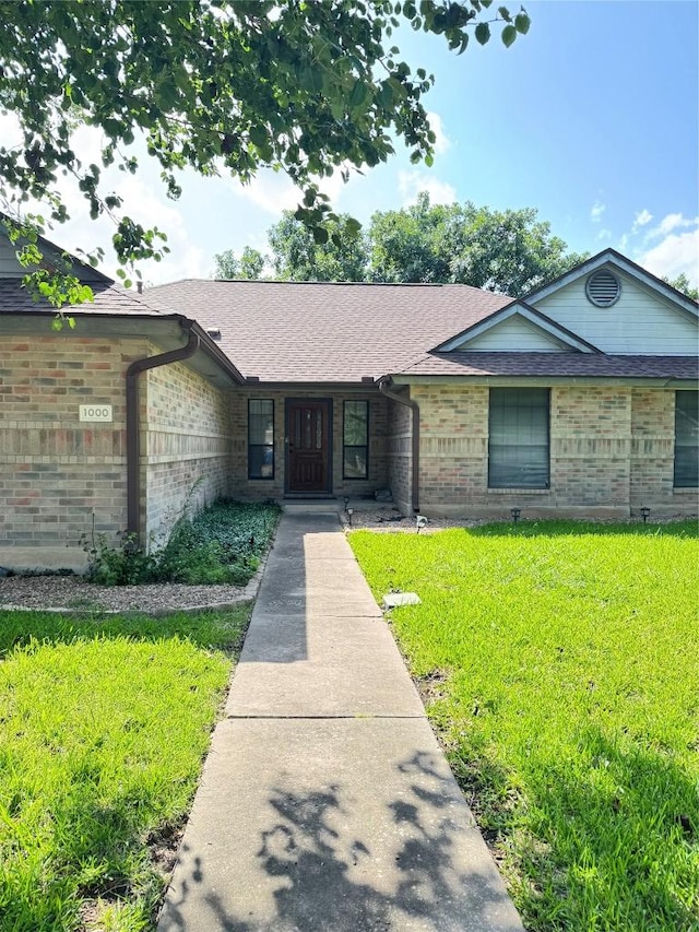 1000 Twin Creek Dr, Pflugerville, TX 78660 - ranch-style house featuring brick siding, a front yard, and roof with shingles