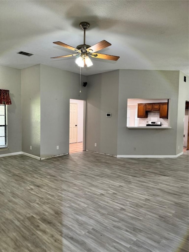1000 Twin Creek Dr, Pflugerville, TX 78660 - unfurnished living room with a ceiling fan and wood finished floors