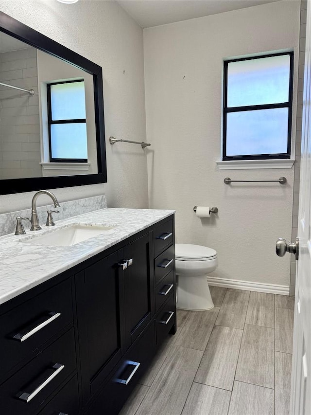 1000 Twin Creek Dr, Pflugerville, TX 78660 - bathroom featuring vanity, wood finish floors, and a shower