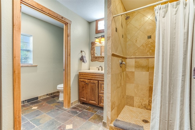 2308 Flite Acres Rd, Wimberley, TX 78676 - full bathroom with stone tile floors, vanity, and a stall shower