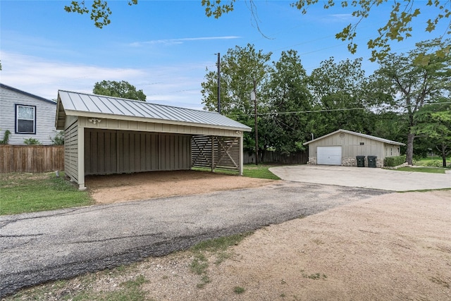 2308 Flite Acres Rd, Wimberley, TX 78676 - detached garage with asphalt driveway and a carport