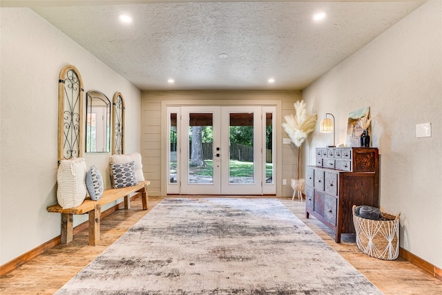 2308 Flite Acres Rd, Wimberley, TX 78676 - entrance foyer featuring french doors, a textured ceiling, wood finished floors, recessed lighting, and a textured wall