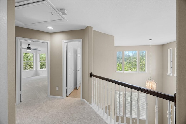 1601 Michael Robert Way, Cedar Park, TX 78613 - hallway featuring attic access, carpet floors, plenty of natural light, a chandelier, and recessed lighting