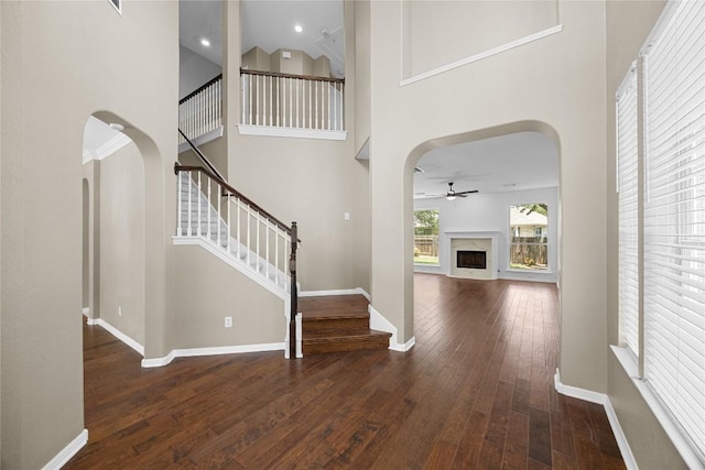 1601 Michael Robert Way, Cedar Park, TX 78613 - entryway featuring arched walkways, ceiling fan, a high end fireplace, hardwood / wood-style floors, and stairs