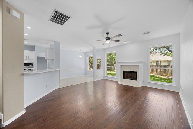 1601 Michael Robert Way, Cedar Park, TX 78613 - unfurnished living room with plenty of natural light, ceiling fan, a fireplace, and dark wood-style floors