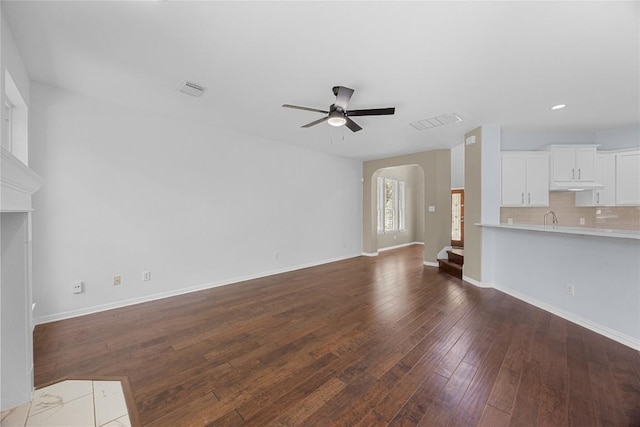 1601 Michael Robert Way, Cedar Park, TX 78613 - unfurnished living room with a ceiling fan, arched walkways, dark wood finished floors, and recessed lighting