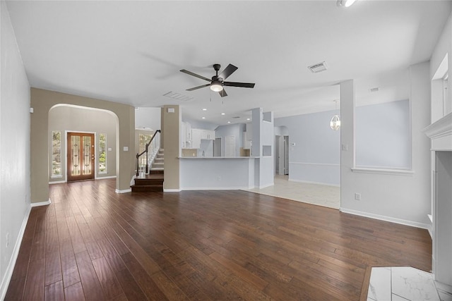 1601 Michael Robert Way, Cedar Park, TX 78613 - unfurnished living room featuring hardwood / wood-style floors, arched walkways, a ceiling fan, and stairway