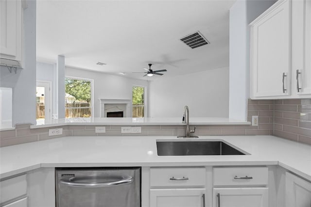 1601 Michael Robert Way, Cedar Park, TX 78613 - kitchen featuring stainless steel dishwasher, ceiling fan, backsplash, light countertops, and white cabinetry