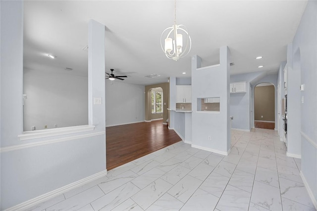 1601 Michael Robert Way, Cedar Park, TX 78613 - kitchen with arched walkways, white cabinetry, a ceiling fan, light marble finish flooring, and a chandelier