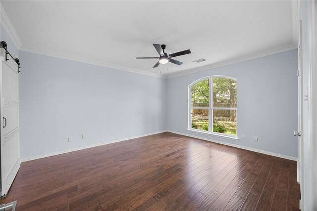 1601 Michael Robert Way, Cedar Park, TX 78613 - unfurnished room featuring a barn door, a ceiling fan, dark wood-style flooring, and crown molding