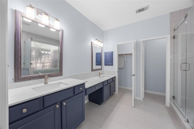 1601 Michael Robert Way, Cedar Park, TX 78613 - bathroom featuring a shower stall, double vanity, a walk in closet, and tile patterned flooring