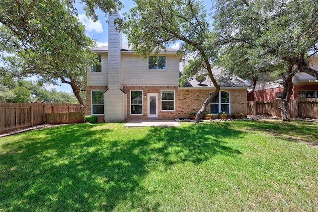 1601 Michael Robert Way, Cedar Park, TX 78613 - back of property with a fenced backyard, a patio, a chimney, and brick siding