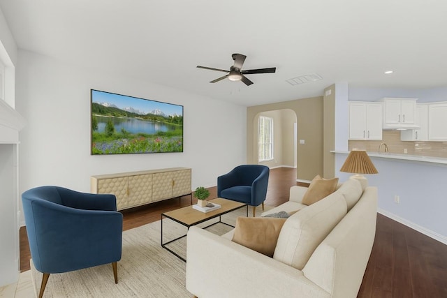 1601 Michael Robert Way, Cedar Park, TX 78613 - living room featuring ceiling fan, arched walkways, wood finished floors, and recessed lighting