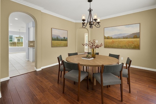 1601 Michael Robert Way, Cedar Park, TX 78613 - dining space with arched walkways, dark wood-style flooring, ornamental molding, a chandelier, and recessed lighting