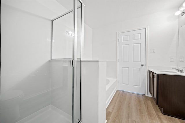 9207 Sandyford Ct, Killeen, TX 76542 - bathroom featuring vanity, wood finished floors, a garden tub, and a stall shower