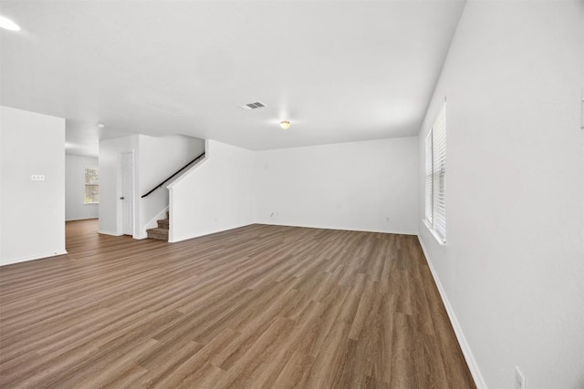 9207 Sandyford Ct, Killeen, TX 76542 - unfurnished living room with stairway and wood finished floors
