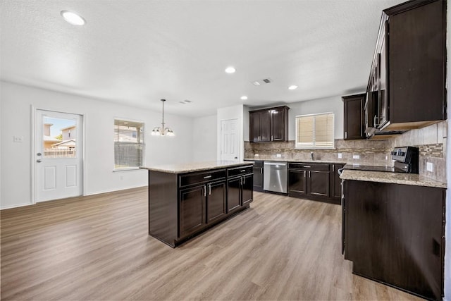 9207 Sandyford Ct, Killeen, TX 76542 - kitchen with dishwasher, light wood finished floors, tasteful backsplash, a chandelier, and dark brown cabinets