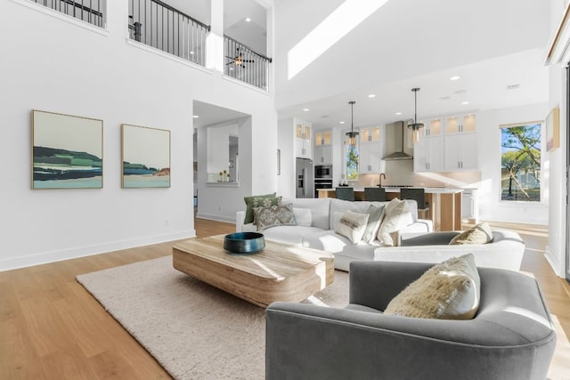 4612 Destination Way, Jonestown, TX 78645 - living area with light wood-style flooring, a high ceiling, and recessed lighting