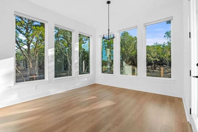 4612 Destination Way, Jonestown, TX 78645 - unfurnished sunroom with wood finished floors, plenty of natural light, and a chandelier