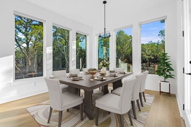 4612 Destination Way, Jonestown, TX 78645 - dining space with light wood-type flooring and a chandelier