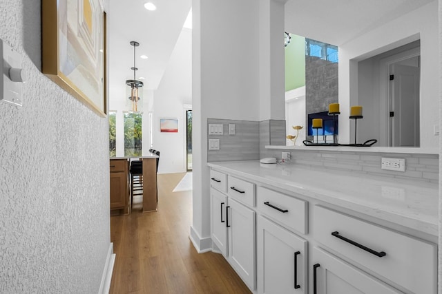 4612 Destination Way, Jonestown, TX 78645 - bathroom with wood finished floors, vanity, tasteful backsplash, and recessed lighting