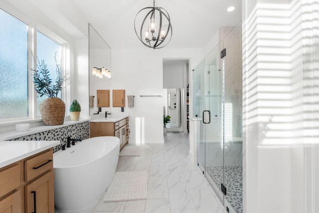 4612 Destination Way, Jonestown, TX 78645 - bathroom with vanity, a stall shower, a chandelier, a soaking tub, and healthy amount of natural light