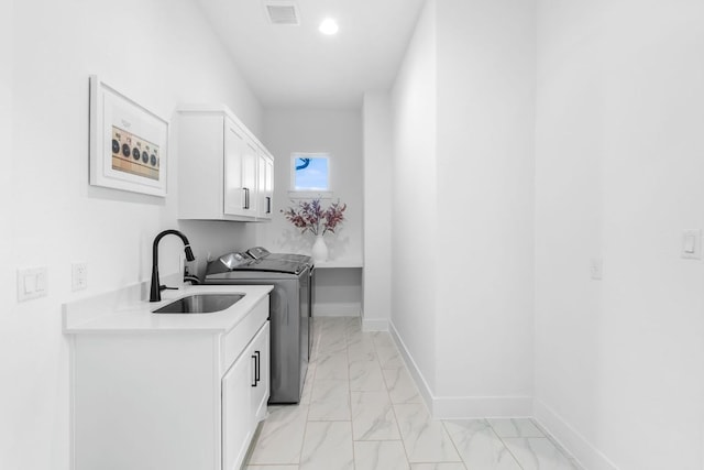4612 Destination Way, Jonestown, TX 78645 - washroom featuring cabinet space, washing machine and clothes dryer, light marble finish flooring, and recessed lighting