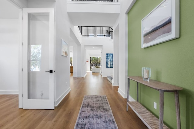 4612 Destination Way, Jonestown, TX 78645 - hallway featuring wood finished floors and a towering ceiling